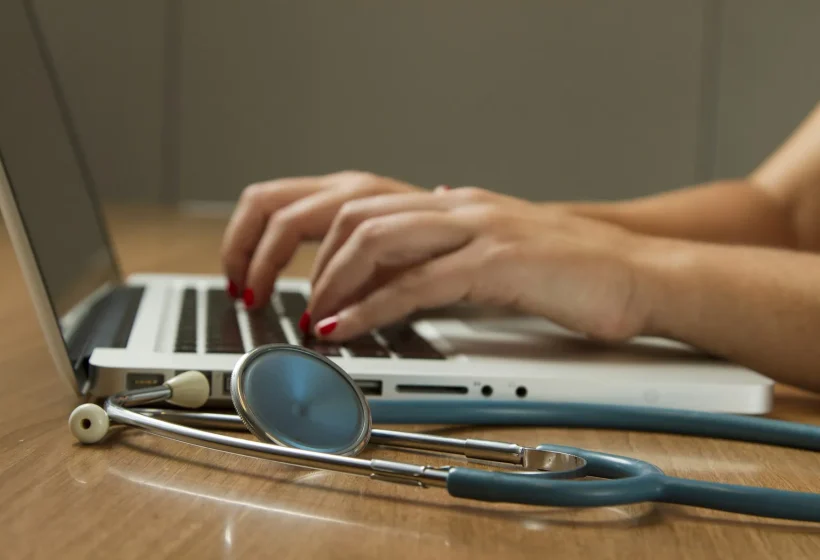 Stethoscope beside a laptop