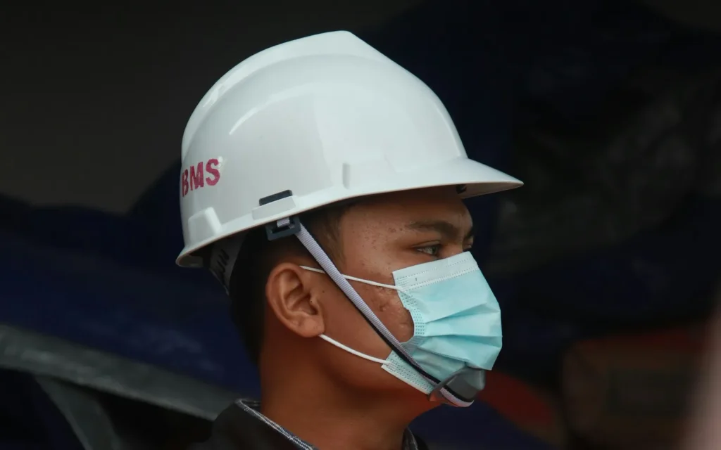 Site worker in safety helmet and vest – occupational health