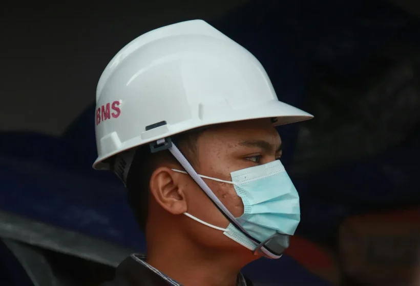 Site worker in safety helmet and vest – occupational health