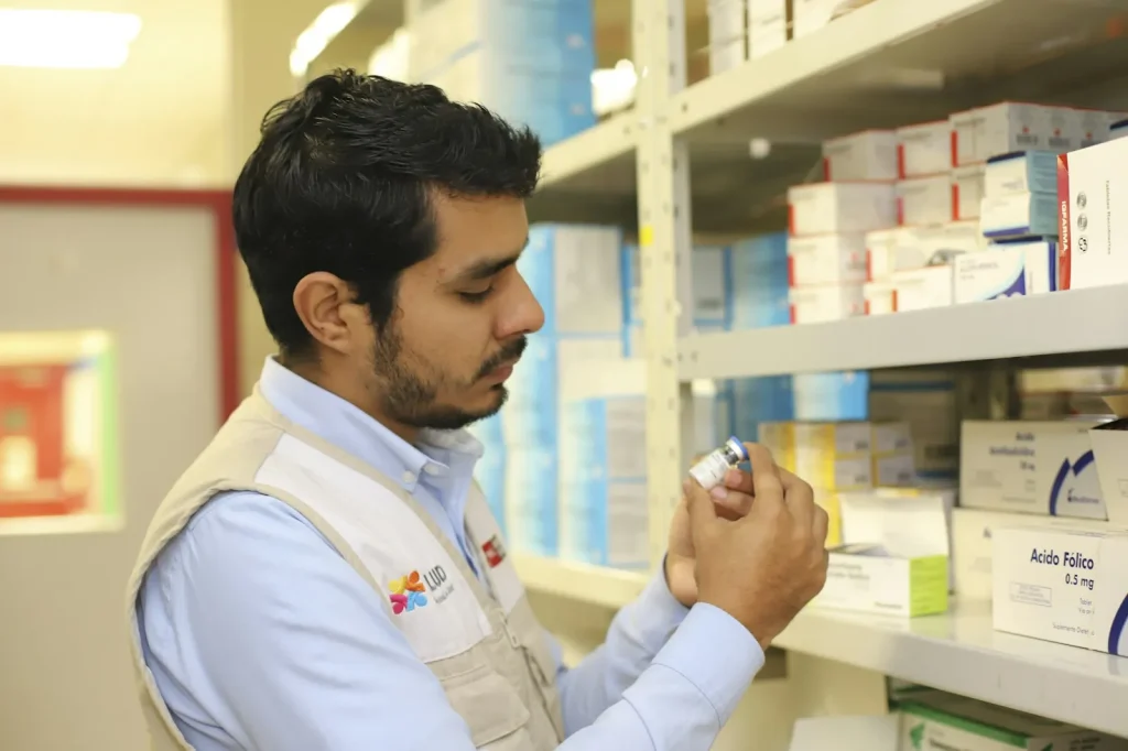 Pharmacist checking medicine stock