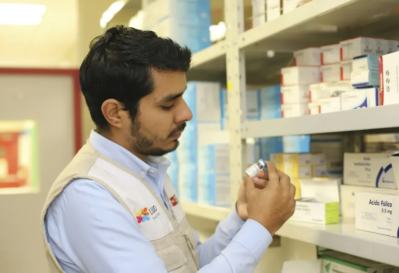Pharmacist checking medicine stock